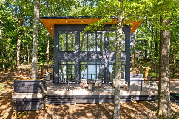 a view of house with yard and sitting area
