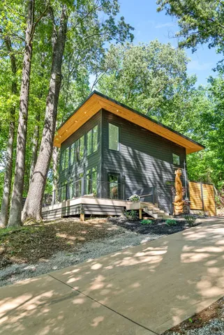 a view of a house with backyard and balcony