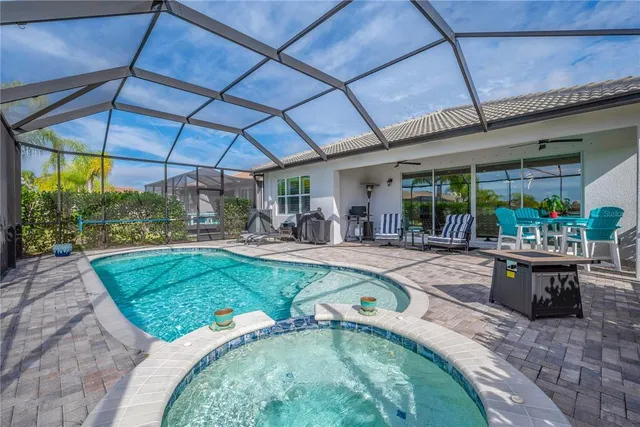 an aerial view of residential houses with outdoor space and lake view