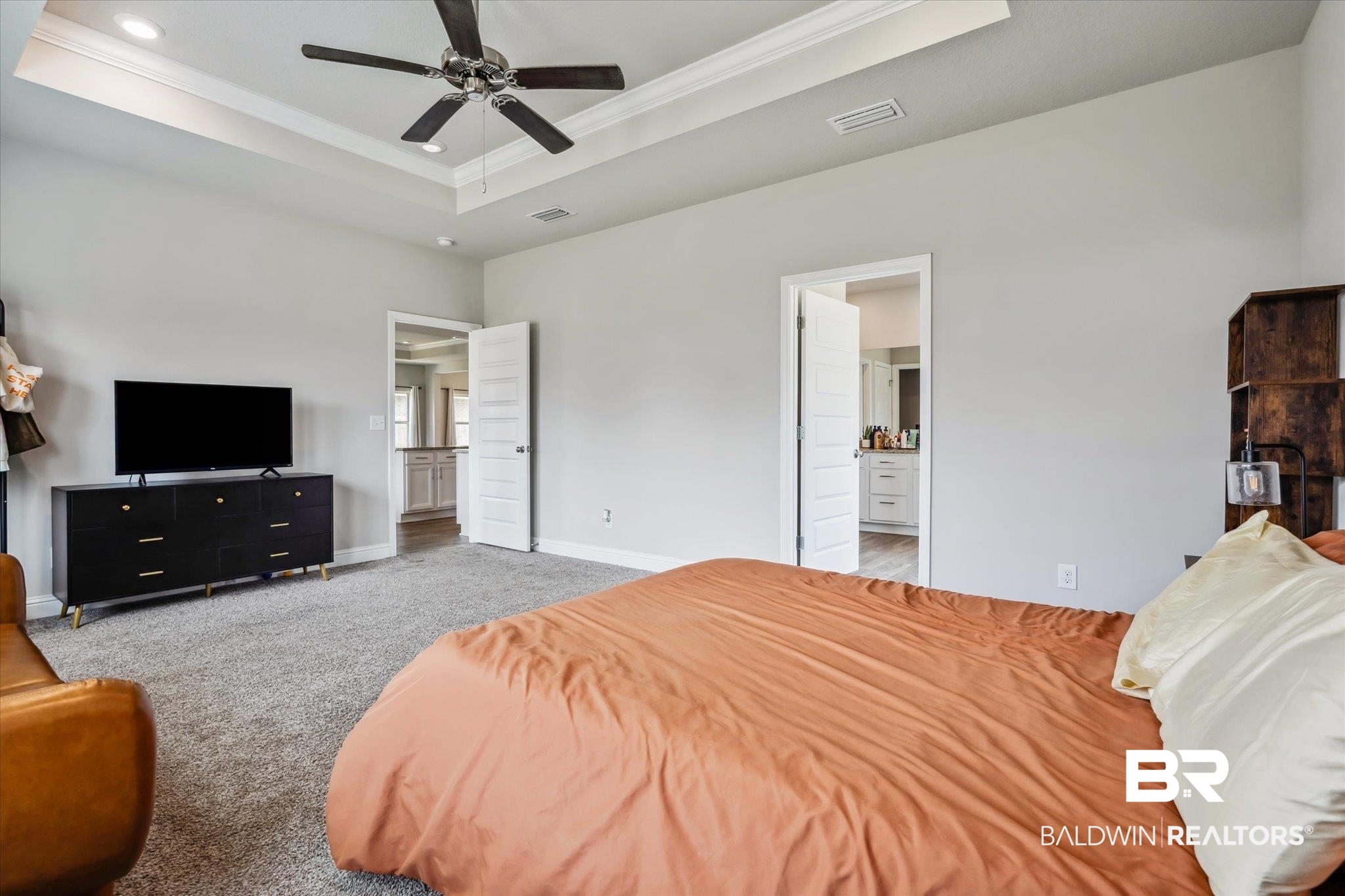 10501 Loamy Avenue Mobile, AL 36695 - Photo 15 of 30 Carpeted bedroom featuring ensuite bathroom, ceiling fan, and a raised ceiling