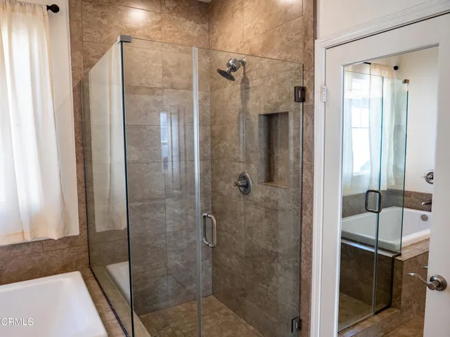 a bathroom with a shower and mirror