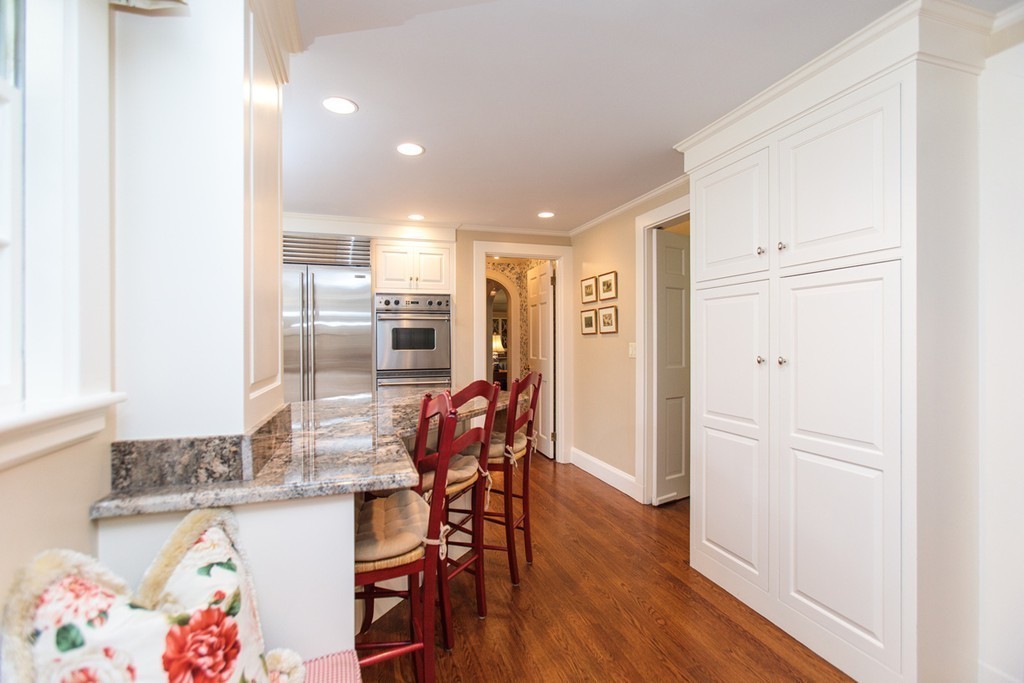 100 Hundreds Road Wellesley, MA 02481 - Photo 8 of 17 a kitchen with stainless steel appliances granite countertop a refrigerator a microwave a stove and a wooden floor