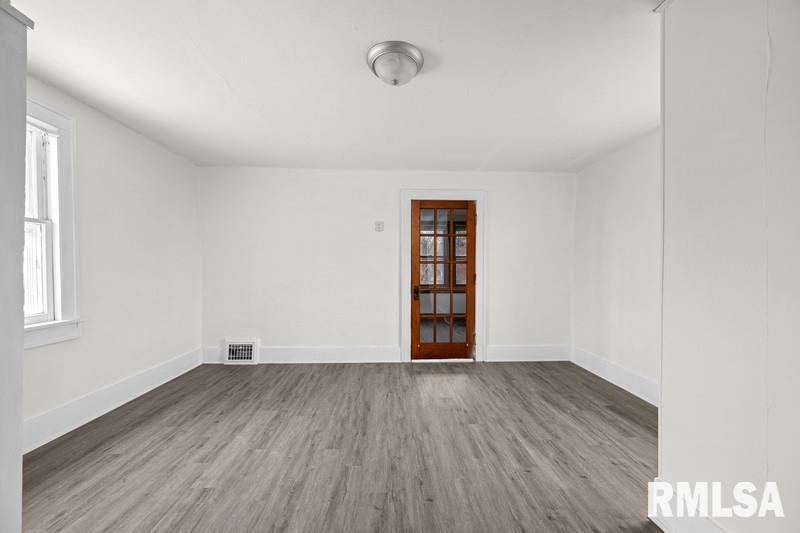 2629 170th Avenue Preemption, IL 61276 - Photo 16 of 21 an empty room with wooden floor and windows