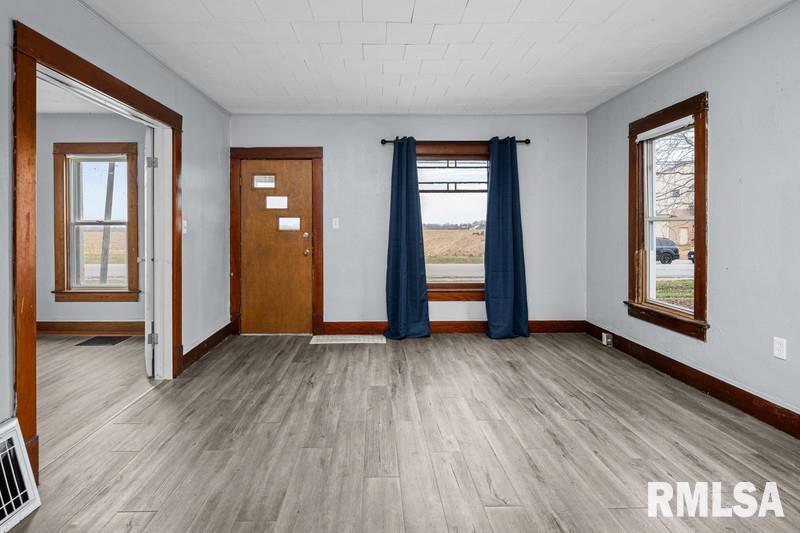 2629 170th Avenue Preemption, IL 61276 - Photo 2 of 21 an empty room with wooden floor and windows