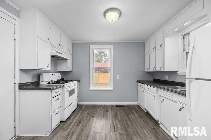 2629 170th Avenue Preemption, IL 61276 - Photo 7 of 21 a kitchen with granite countertop a sink a stove and cabinets