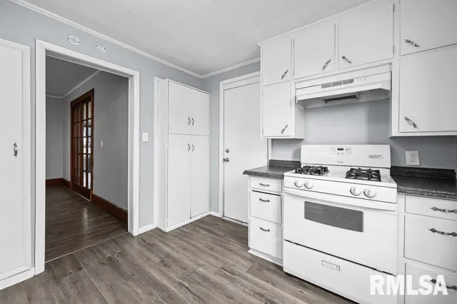 a kitchen with white cabinets and white appliances