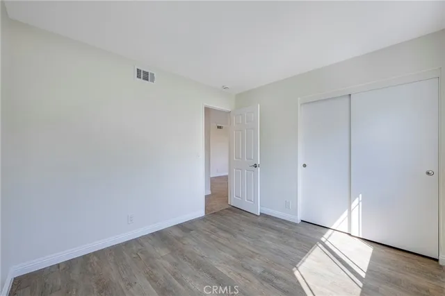 a view of an empty room and wooden floor