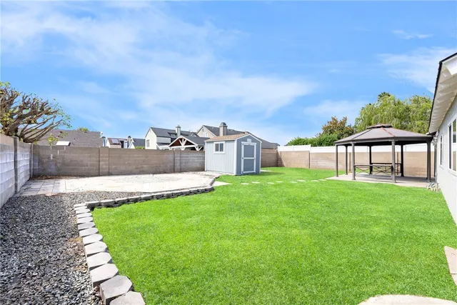 a view of a patio with table and chairs with wooden fence