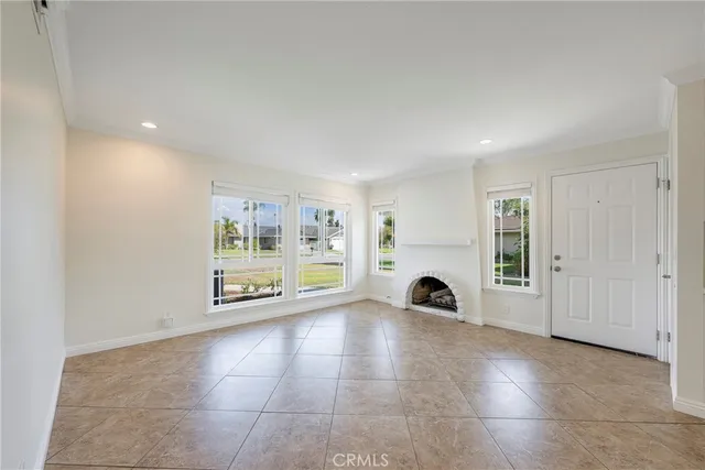 a view of a livingroom with a fireplace and window
