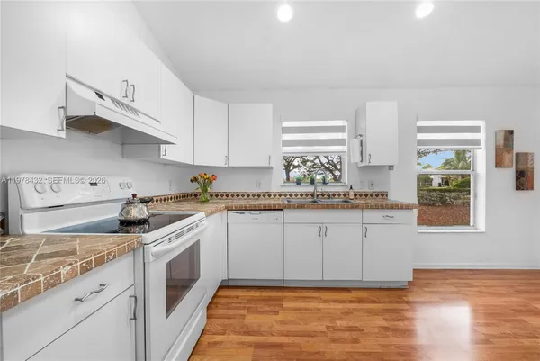 a kitchen with a sink cabinets and window