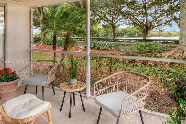 a view of a chair and tables in the patio