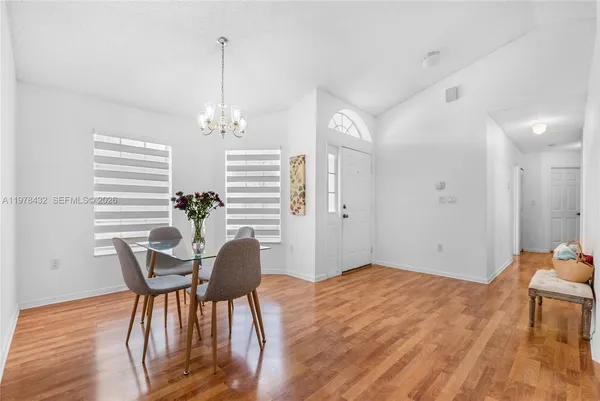a furnished dining room with furniture window and wooden floor