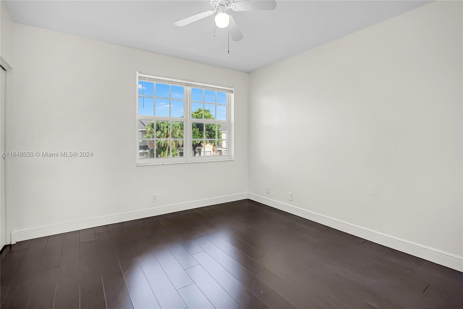 56 Truman Drive Weston, FL 33326 - Photo 11 of 24 an empty room with wooden floor and windows