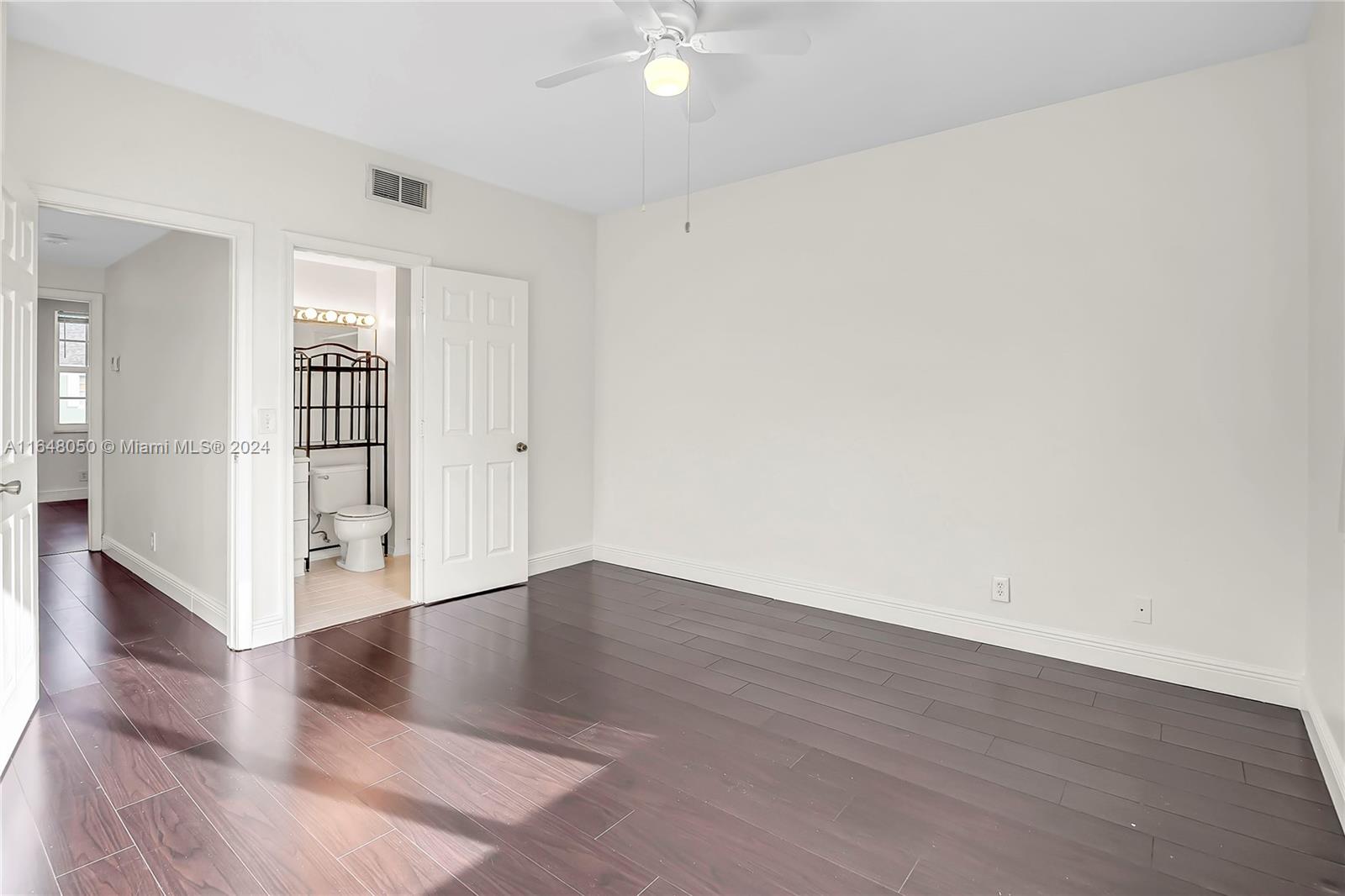 56 Truman Drive Weston, FL 33326 - Photo 16 of 24 an empty room with wooden floor and windows