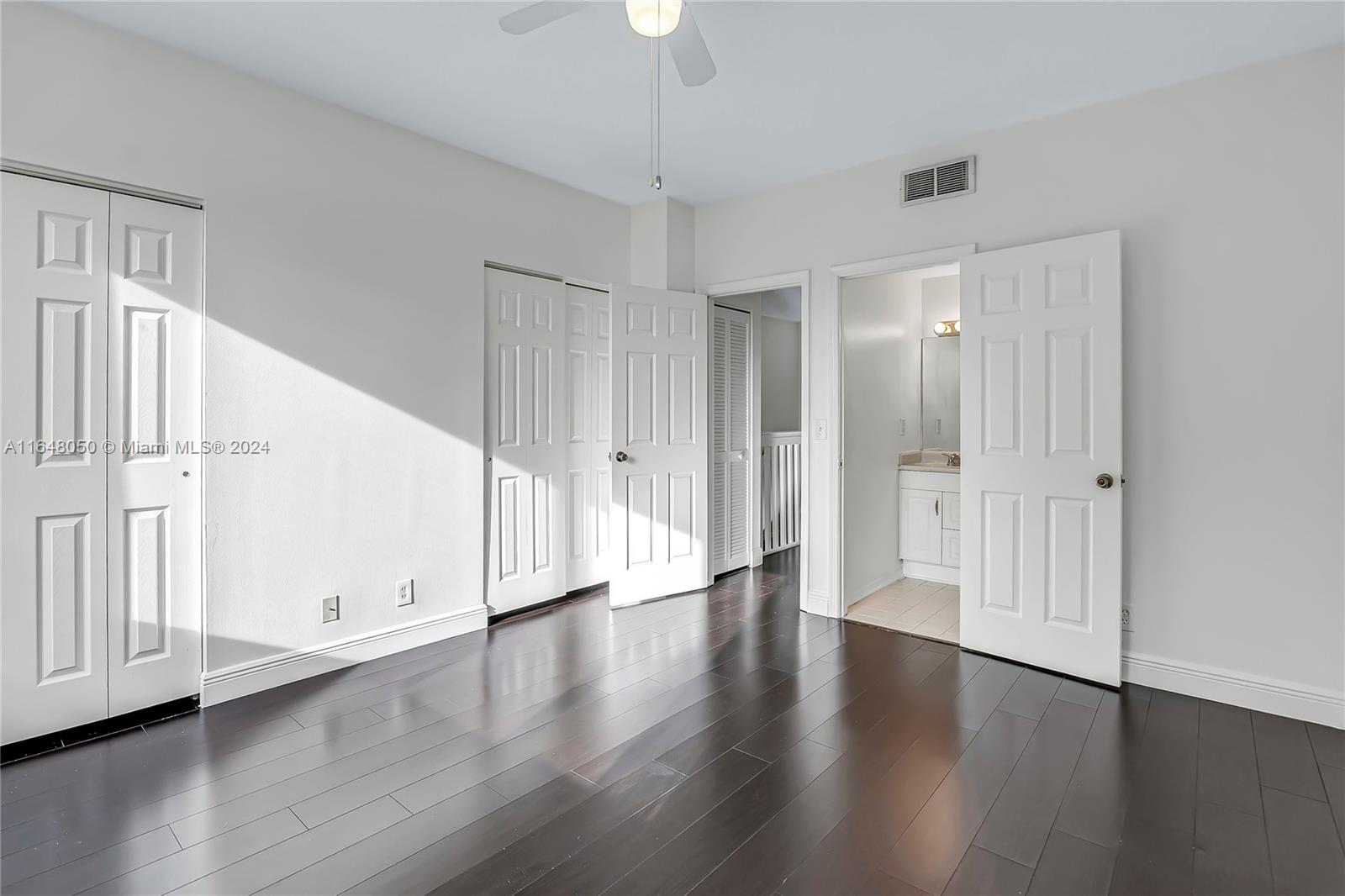 56 Truman Drive Weston, FL 33326 - Photo 17 of 24 a view of an empty room with wooden floor