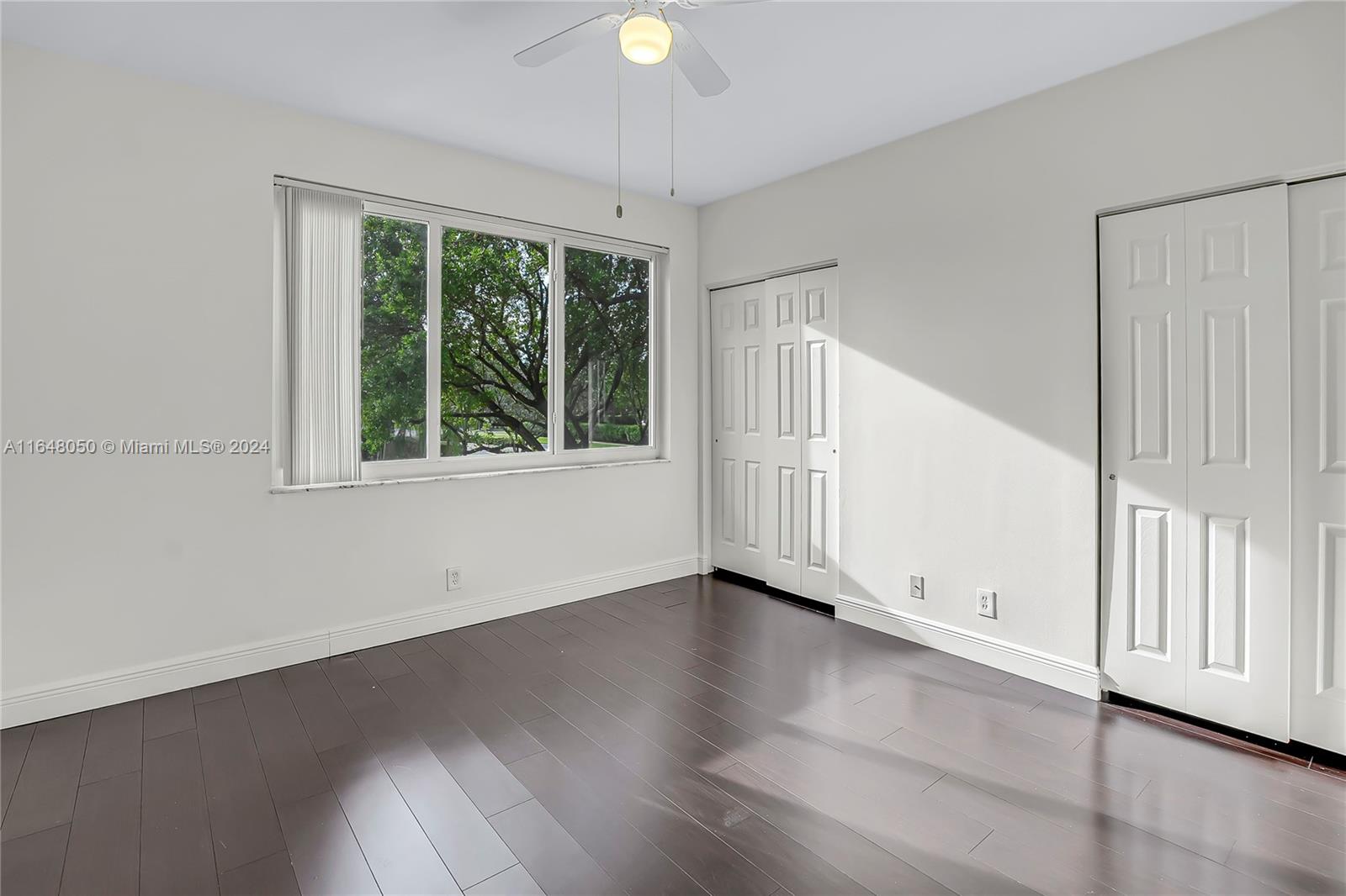 56 Truman Drive Weston, FL 33326 - Photo 19 of 24 an empty room with wooden floor and windows