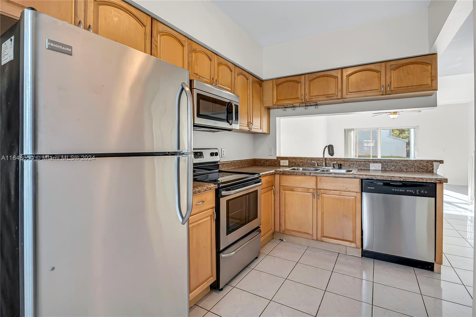 56 Truman Drive Weston, FL 33326 - Photo 4 of 24 a kitchen with stainless steel appliances granite countertop a refrigerator and a sink