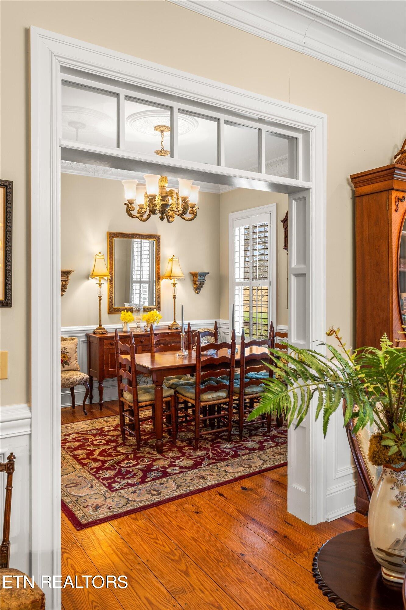 7016 Castlewood Road Knoxville, TN 37931 - Photo 15 of 58 a view of a dining room with furniture a potted plant and wooden floor