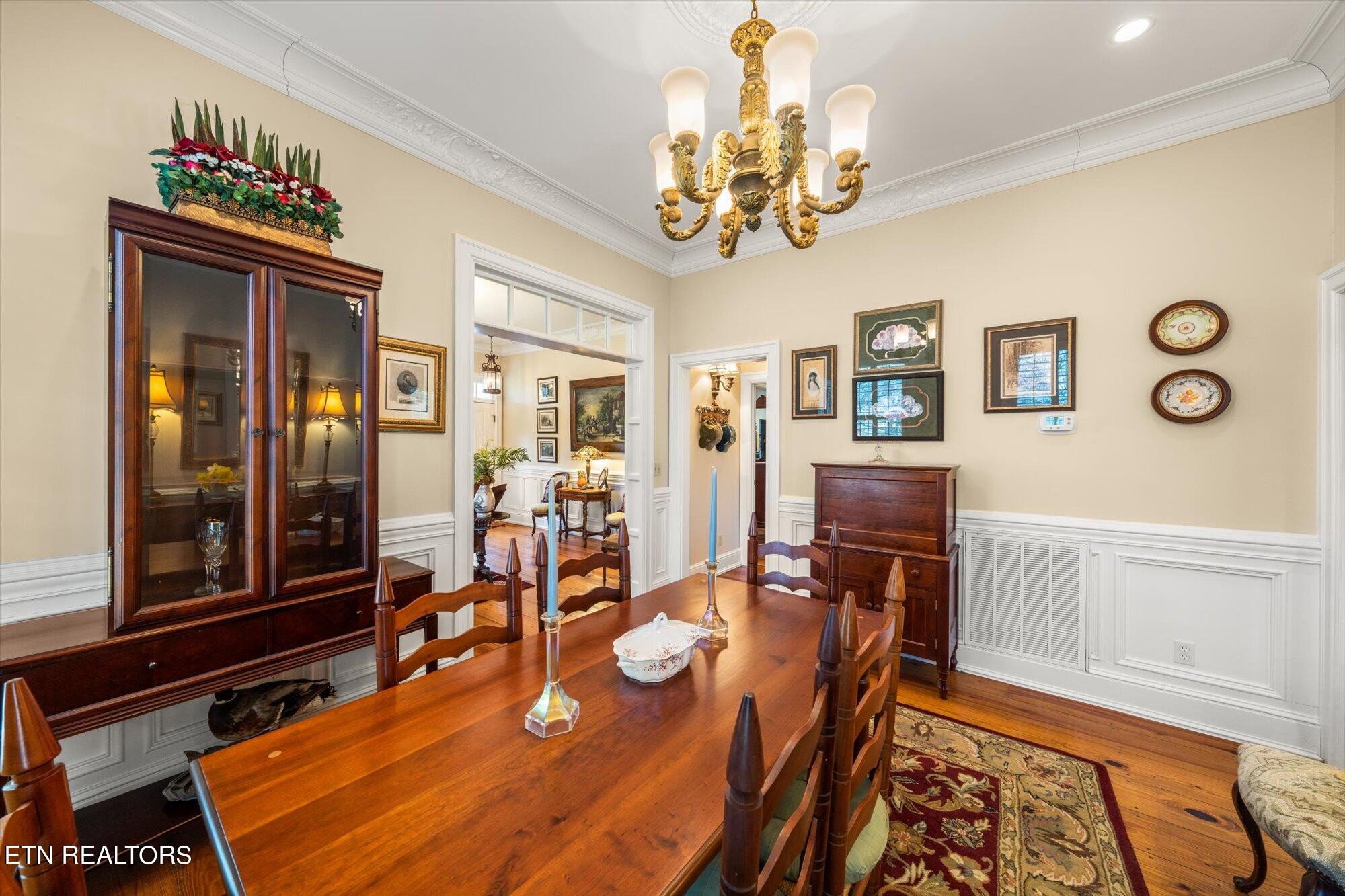 7016 Castlewood Road Knoxville, TN 37931 - Photo 18 of 58 a view of a dining room with furniture a chandelier and wooden floor