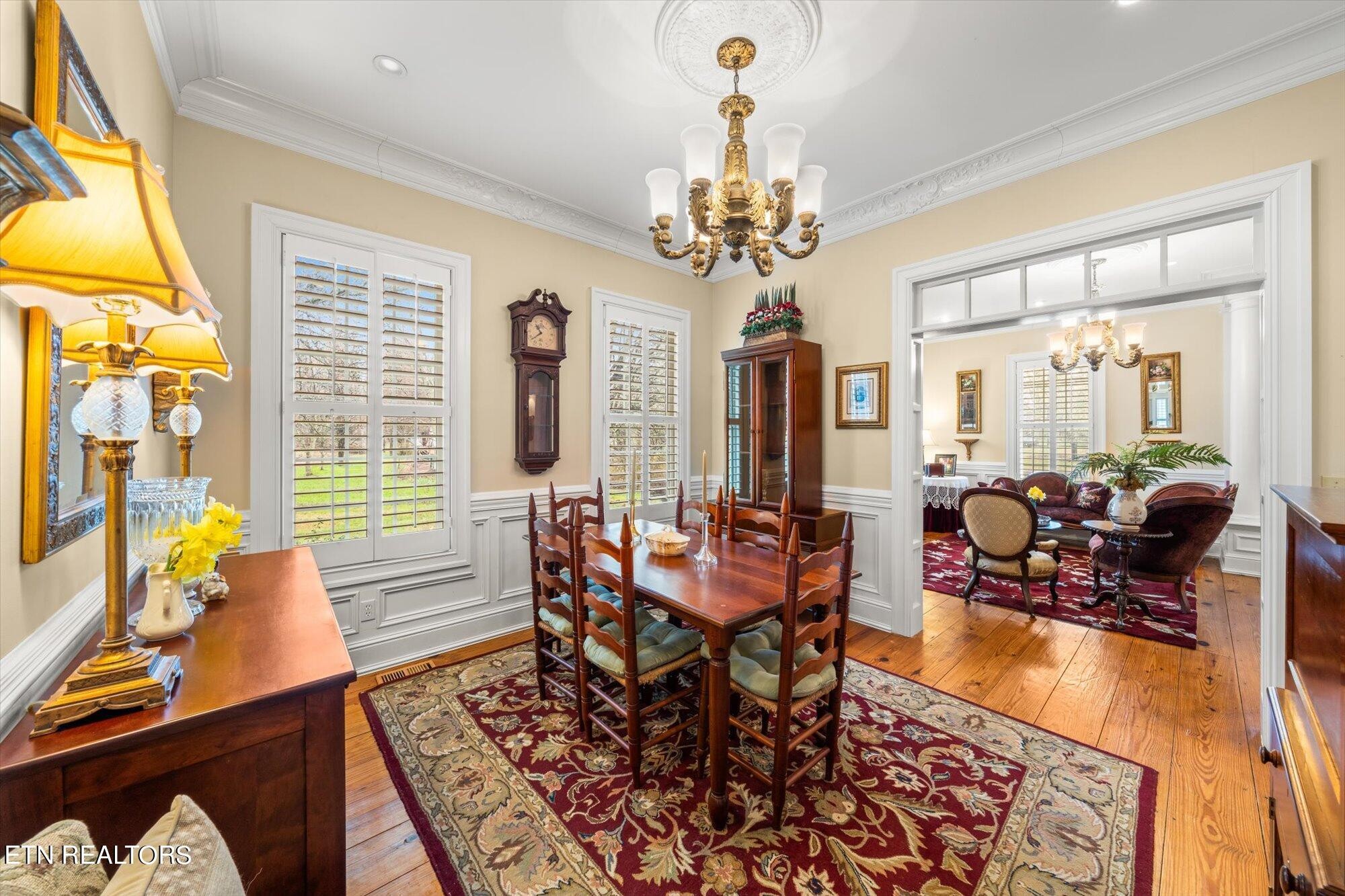 7016 Castlewood Road Knoxville, TN 37931 - Photo 19 of 58 a living room with furniture a chandelier and a table