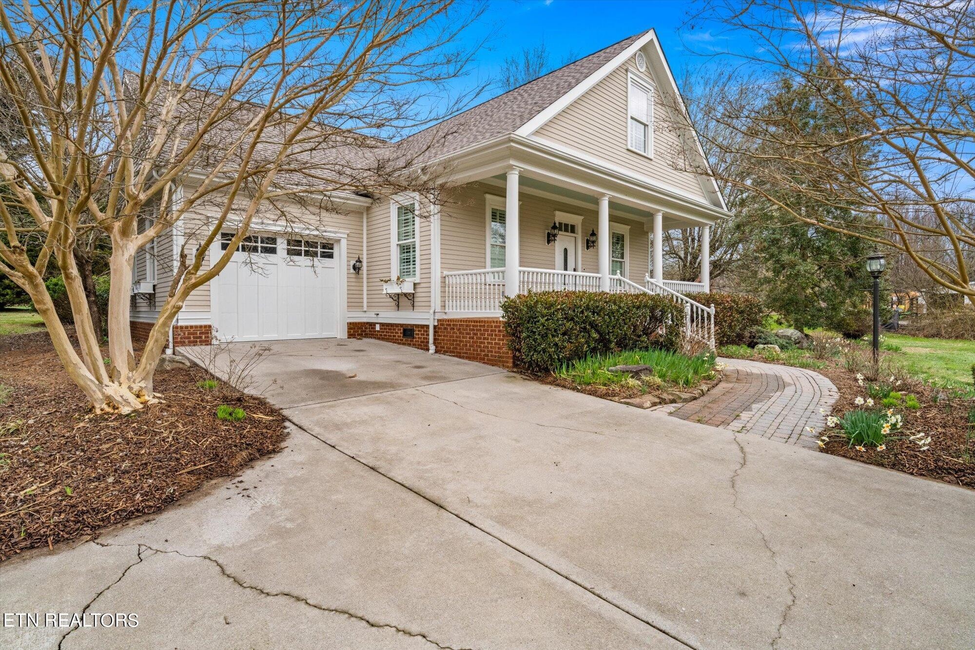 7016 Castlewood Road Knoxville, TN 37931 - Photo 2 of 58 a front view of a house with a garden