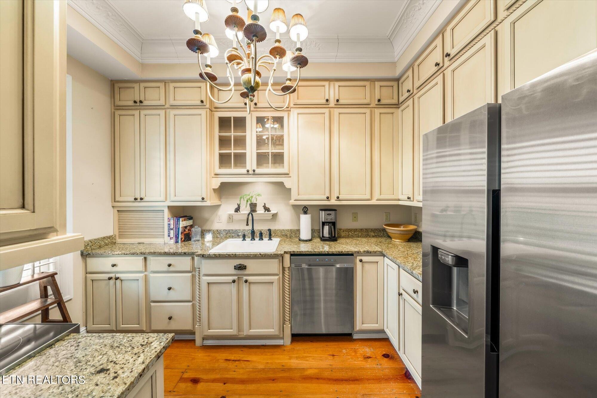 7016 Castlewood Road Knoxville, TN 37931 - Photo 24 of 58 a kitchen with a sink stove and cabinets
