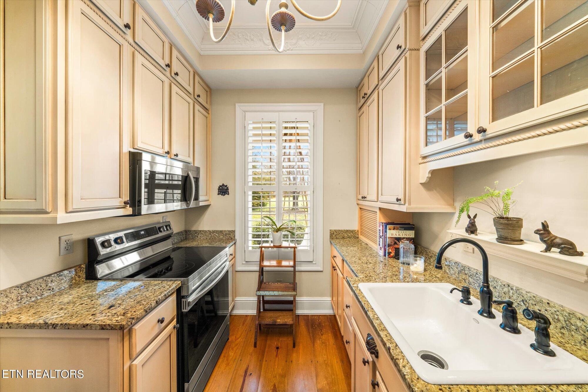 7016 Castlewood Road Knoxville, TN 37931 - Photo 25 of 58 a kitchen with granite countertop a sink a counter space appliances and cabinets