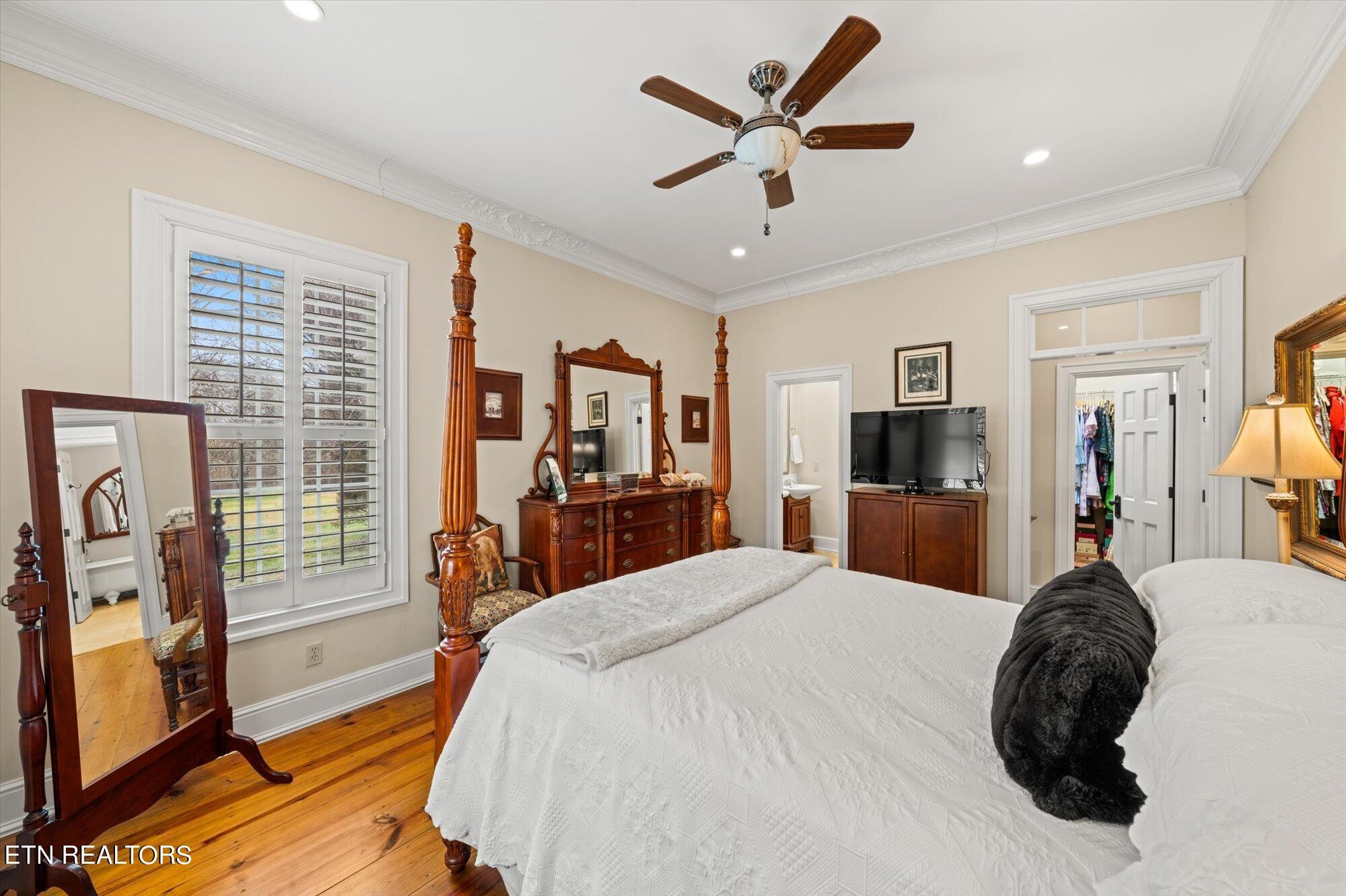 7016 Castlewood Road Knoxville, TN 37931 - Photo 31 of 58 a large bedroom with a bed and a flat screen tv