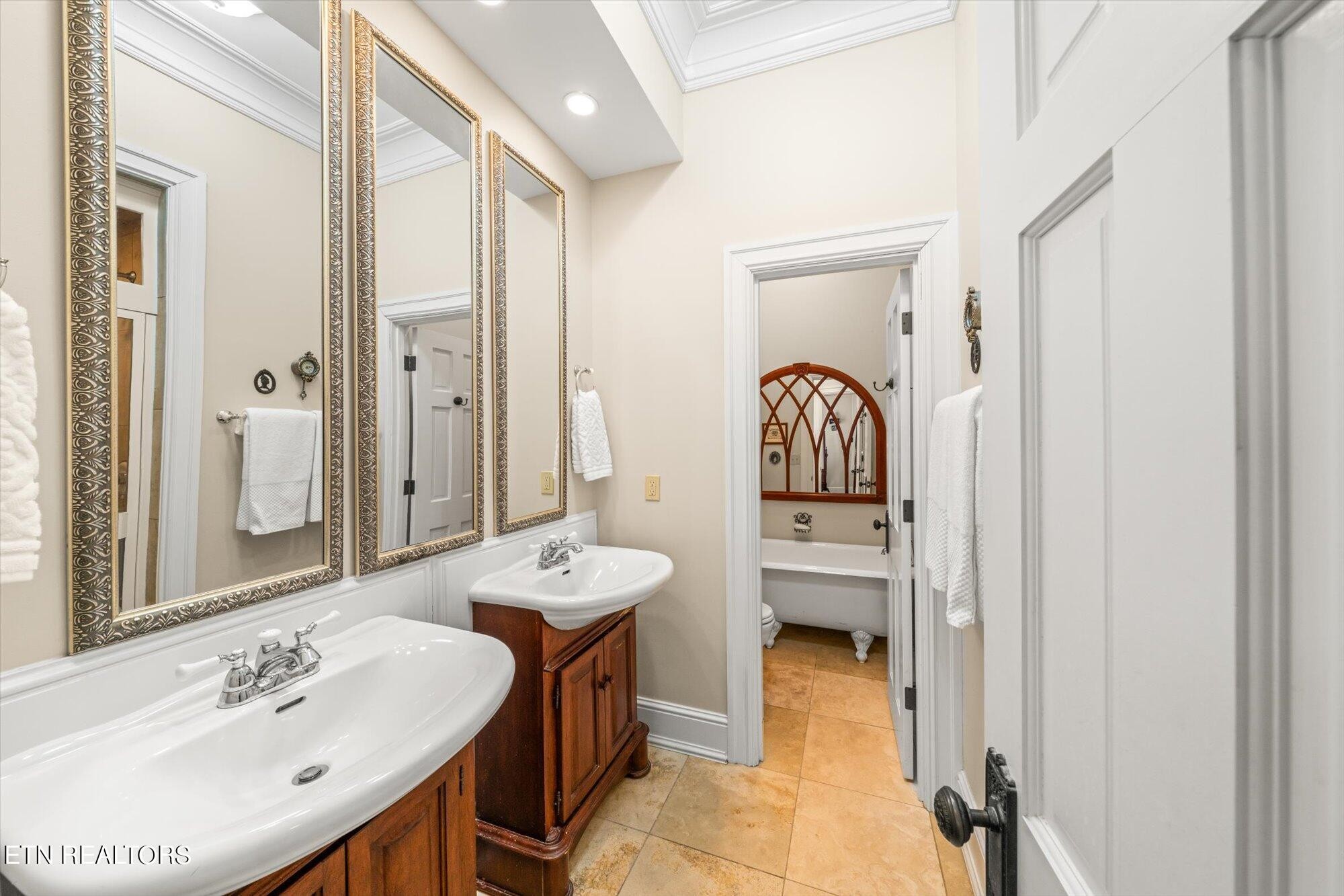 7016 Castlewood Road Knoxville, TN 37931 - Photo 32 of 58 a en suite bathroom with a sink and a mirror