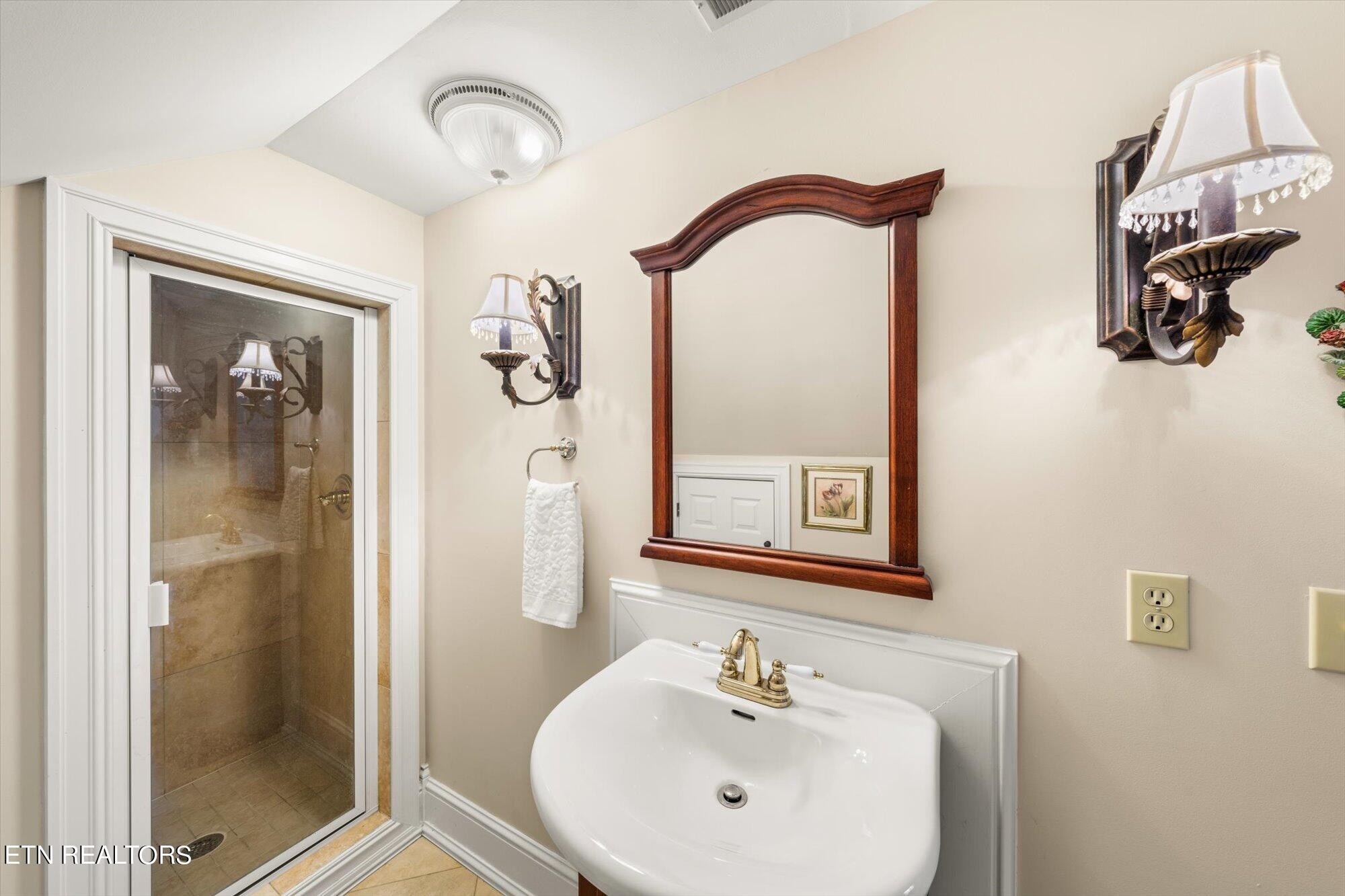 7016 Castlewood Road Knoxville, TN 37931 - Photo 44 of 58 a bathroom with a sink and mirror
