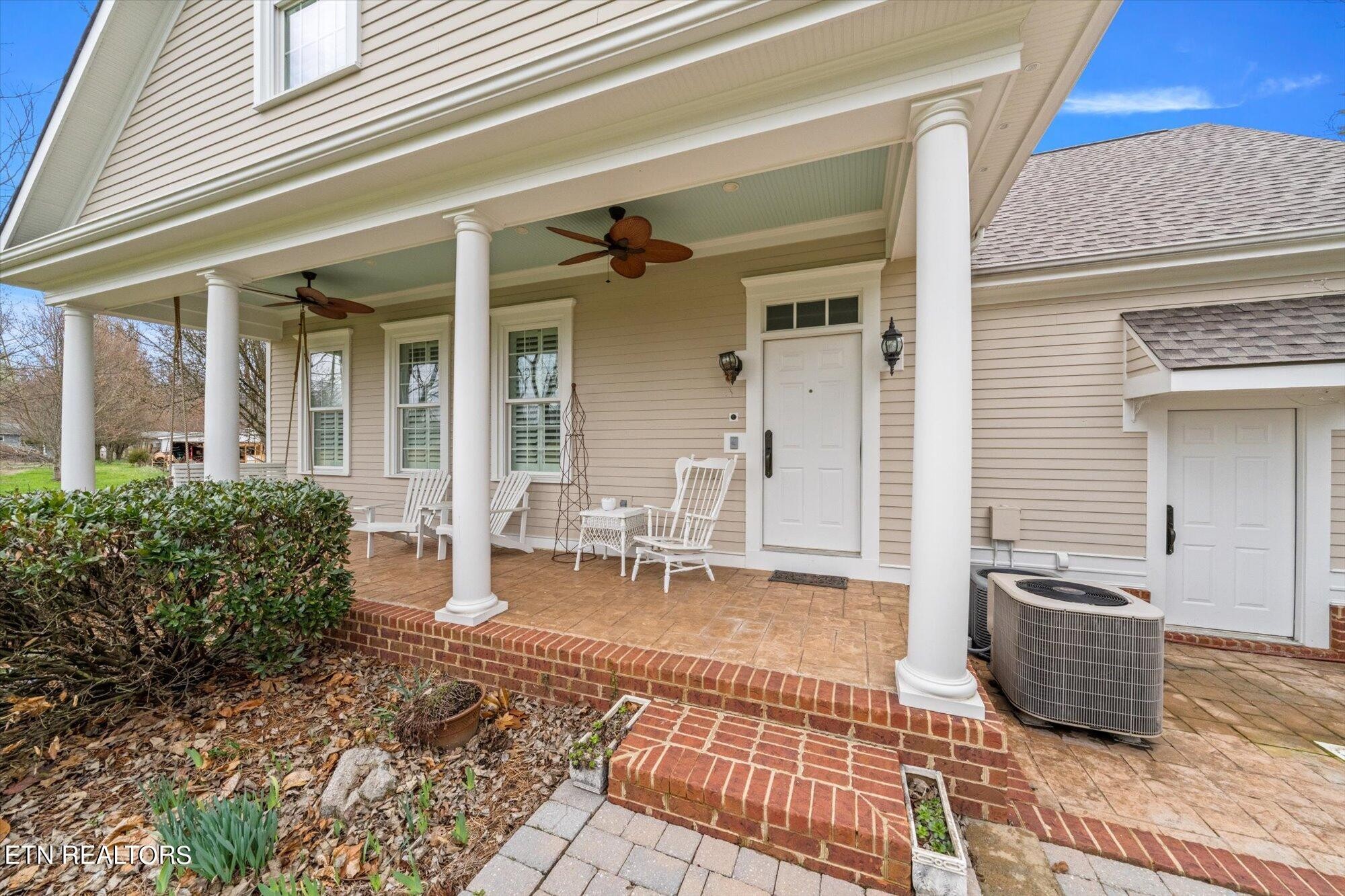 7016 Castlewood Road Knoxville, TN 37931 - Photo 47 of 58 a view of a patio with table and chairs and wooden fence