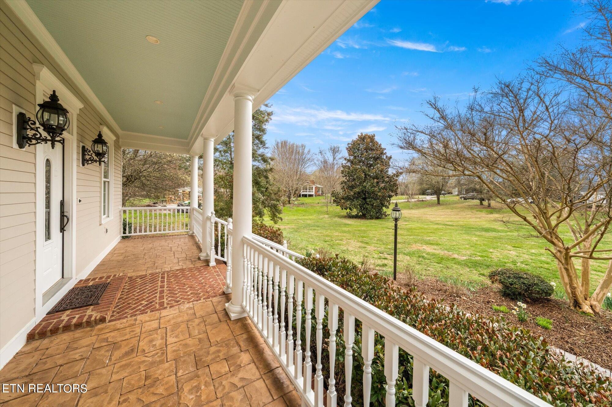 7016 Castlewood Road Knoxville, TN 37931 - Photo 9 of 58 a view of a porch with wooden floor and fence