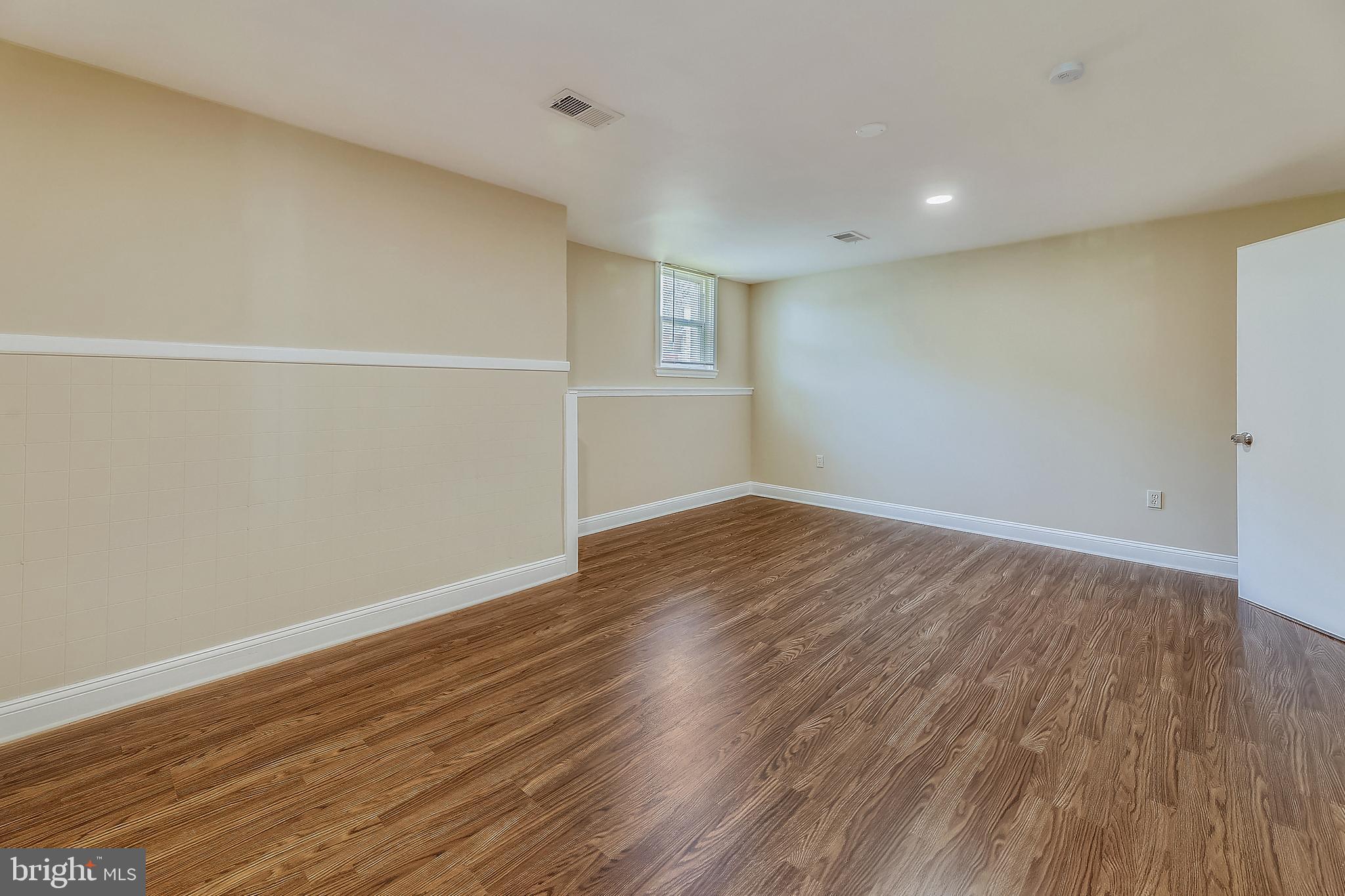1321 Maple Avenue Baltimore, MD 21227 - Photo 11 of 30 a view of an empty room with wooden floor