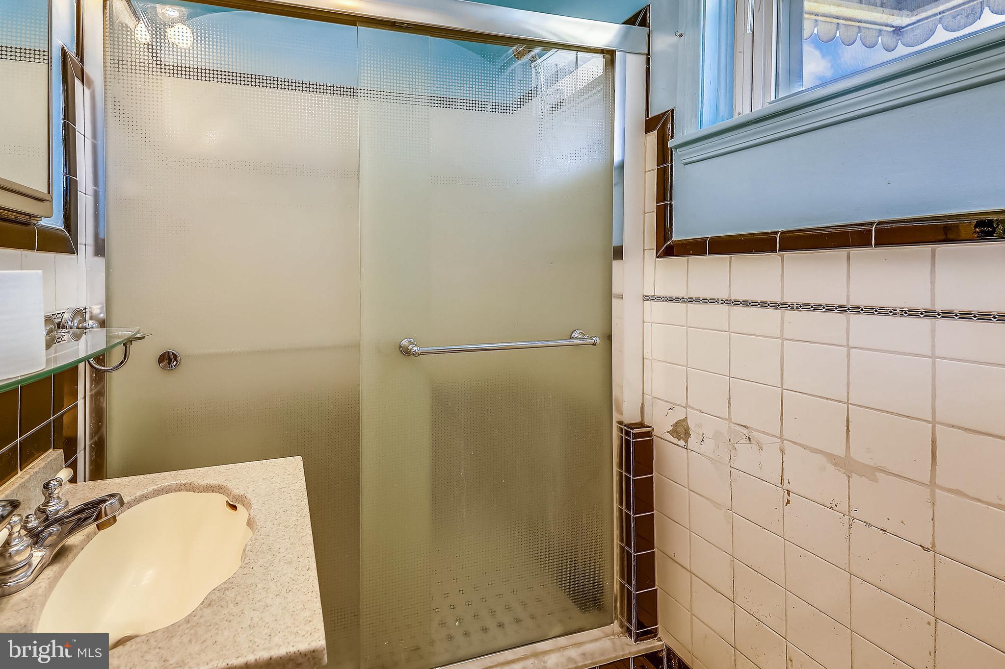 1321 Maple Avenue Baltimore, MD 21227 - Photo 14 of 30 a bathroom with a granite countertop shower and a sink