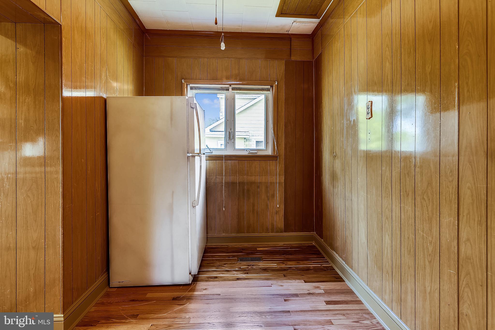 1321 Maple Avenue Baltimore, MD 21227 - Photo 17 of 30 a view of a hallway with wooden floor