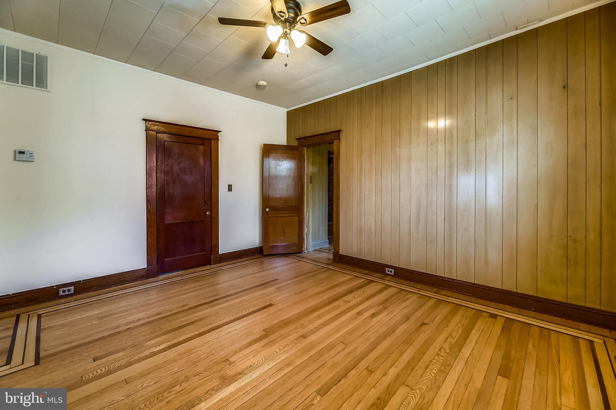 1321 Maple Avenue Baltimore, MD 21227 - Photo 22 of 30 a view of an empty room with wooden floor