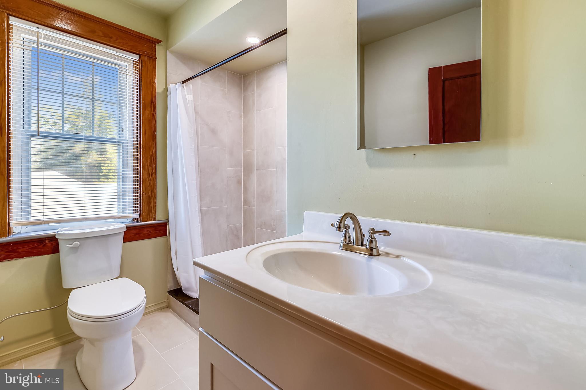 1321 Maple Avenue Baltimore, MD 21227 - Photo 25 of 30 a bathroom with a sink a toilet and tub