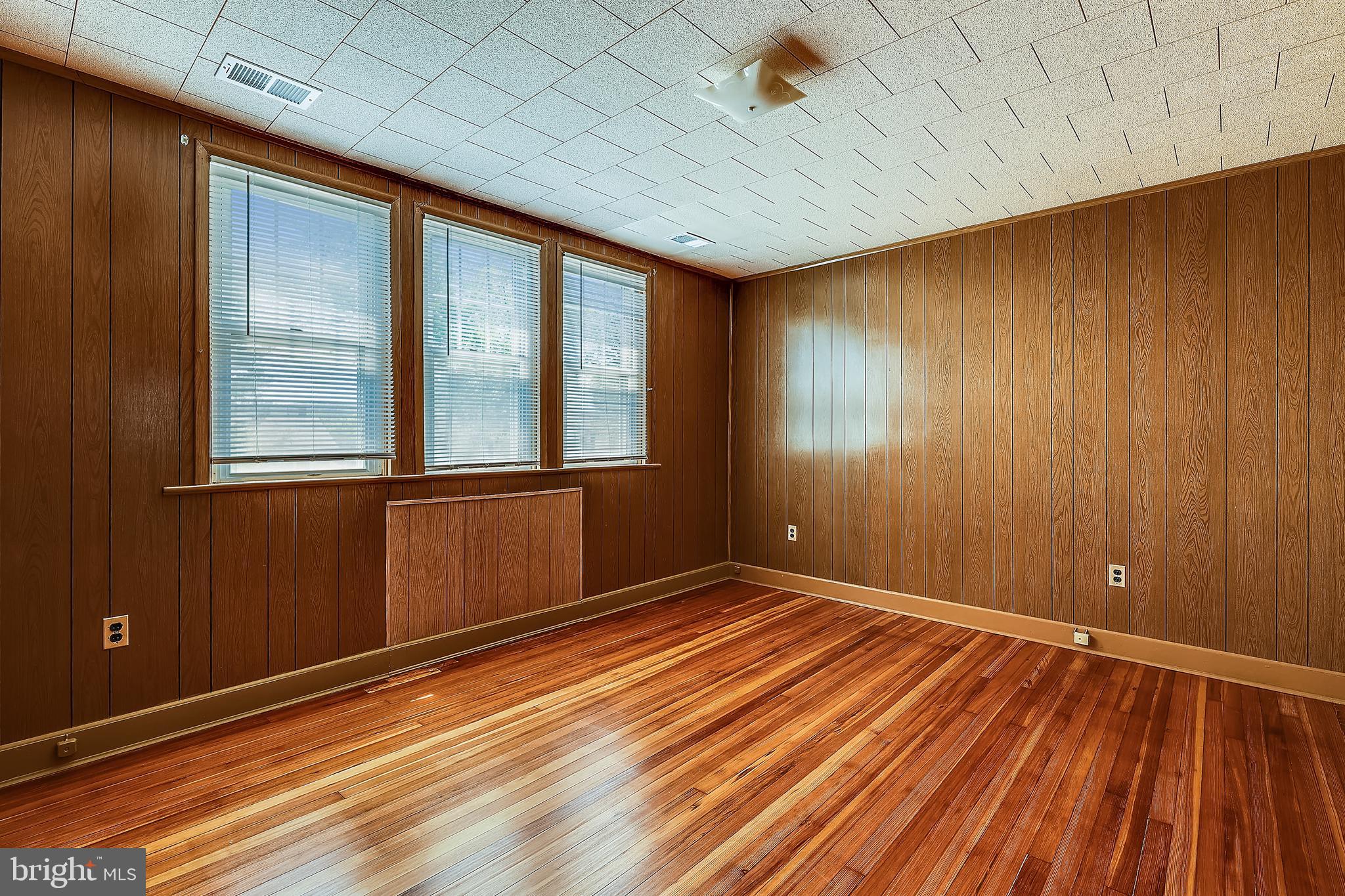 1321 Maple Avenue Baltimore, MD 21227 - Photo 26 of 30 a view of an empty room with wooden floor and a window