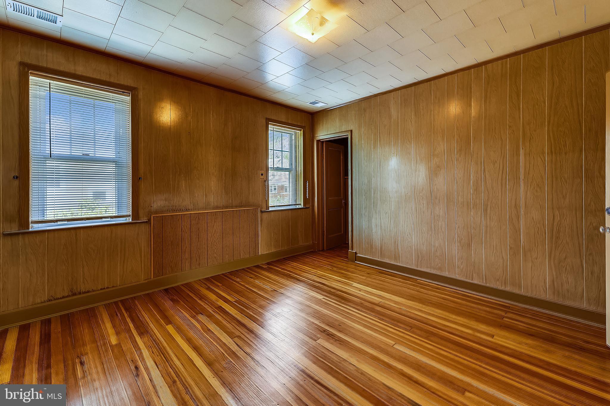 1321 Maple Avenue Baltimore, MD 21227 - Photo 27 of 30 a view of an empty room with wooden floor and a window