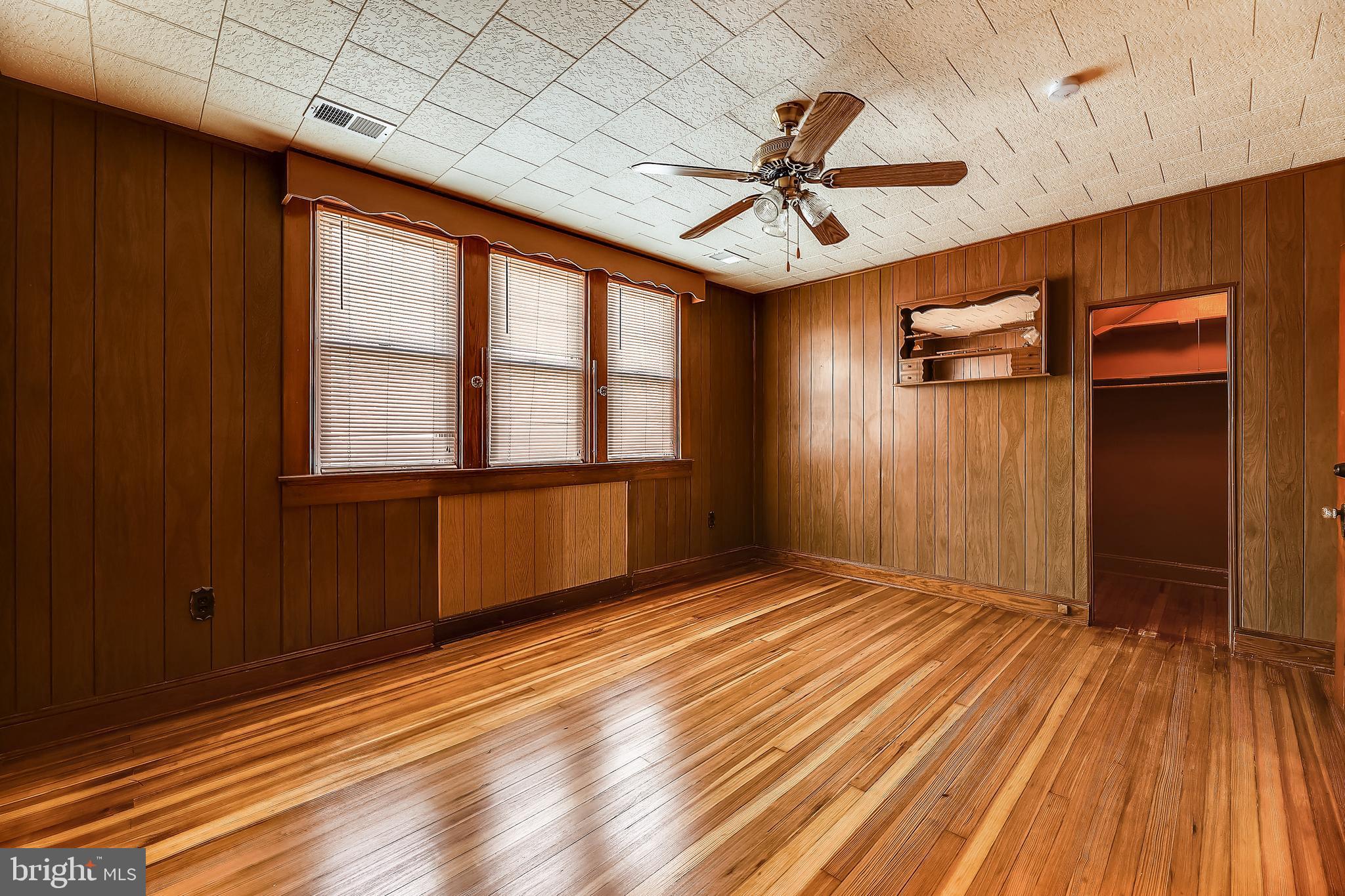 1321 Maple Avenue Baltimore, MD 21227 - Photo 28 of 30 wooden floor in an empty room with a window