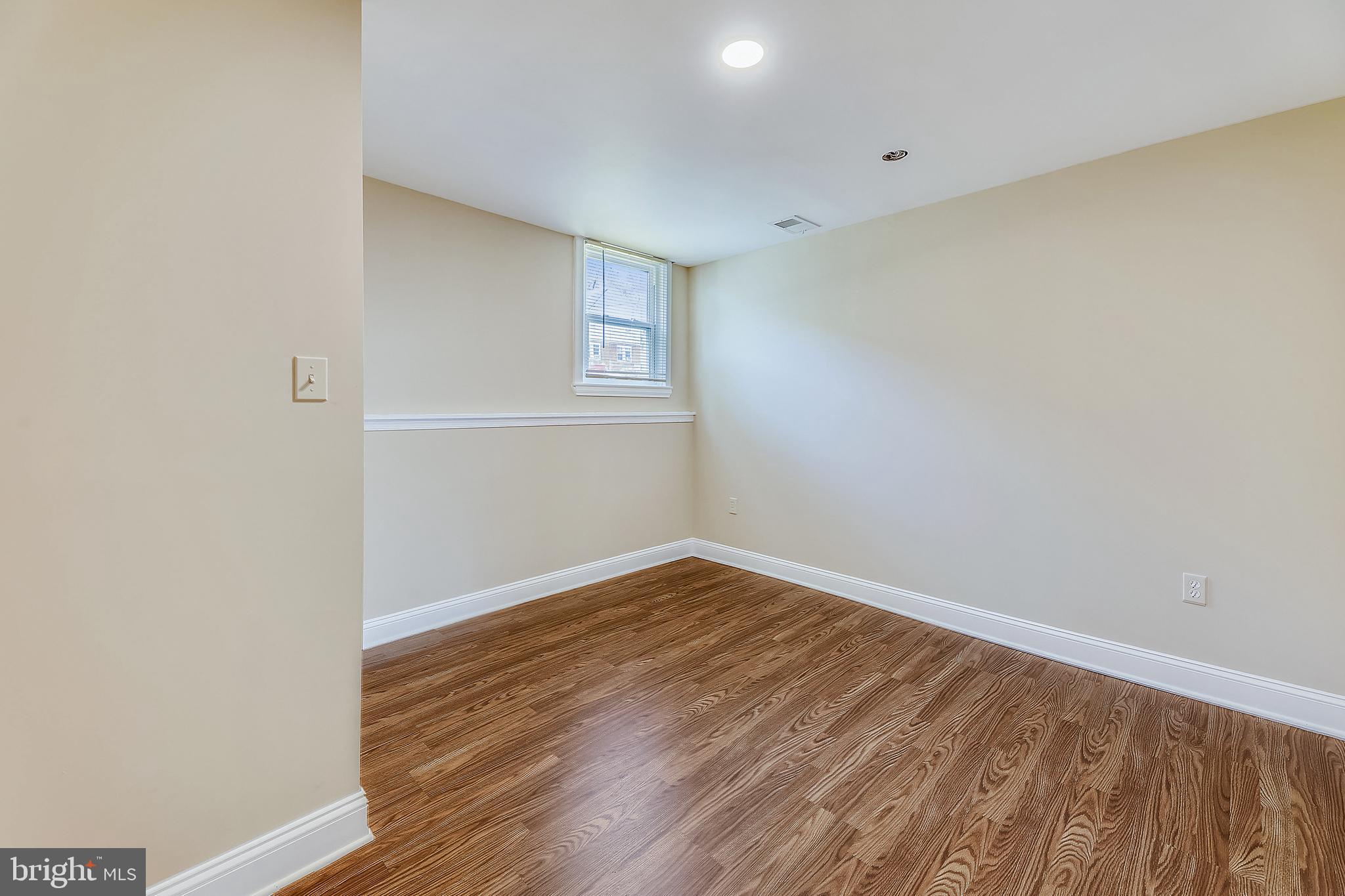 1321 Maple Avenue Baltimore, MD 21227 - Photo 10 of 30 a view of an empty room with wooden floor