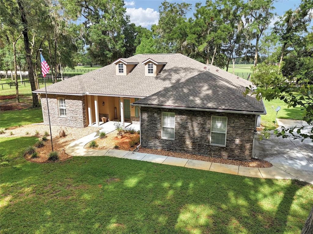 1989 Northwest 111th Loop Ocala, FL 34475 - Photo 43 of 55 a front view of a house with garden