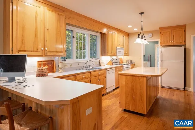 a kitchen with a sink stove and refrigerator