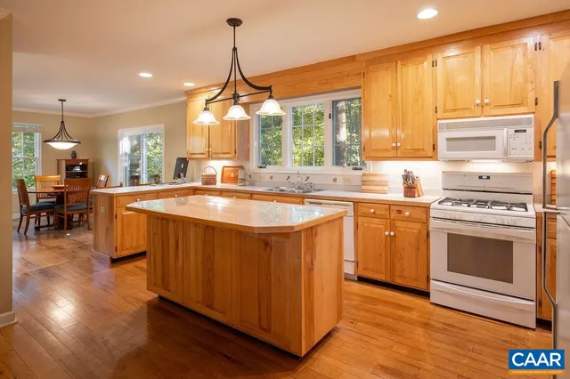 a kitchen with stainless steel appliances a sink a stove a refrigerator and cabinets