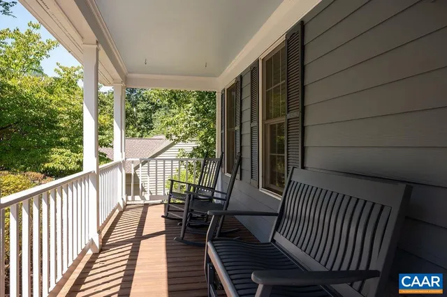 a view of balcony with wooden floor and outdoor seating