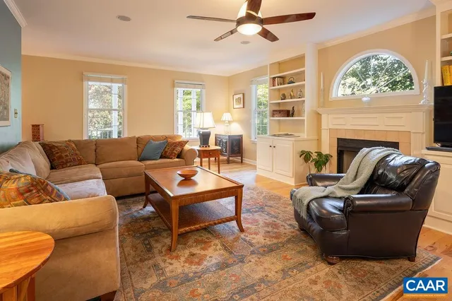 a living room with furniture a fireplace and a large window