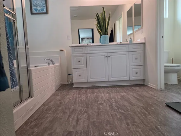 a bathroom with a bathtub sink and mirror