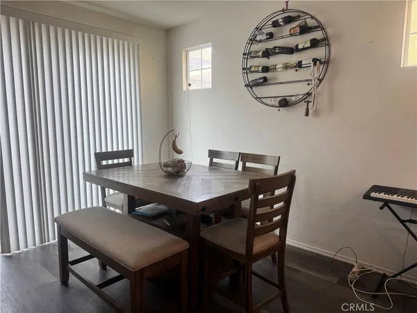 a view of a dining room with furniture wooden floor and a chandelier