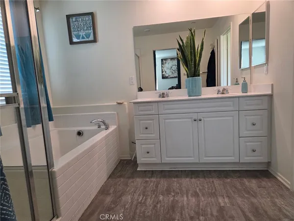 a bathroom with a tub sink and mirror
