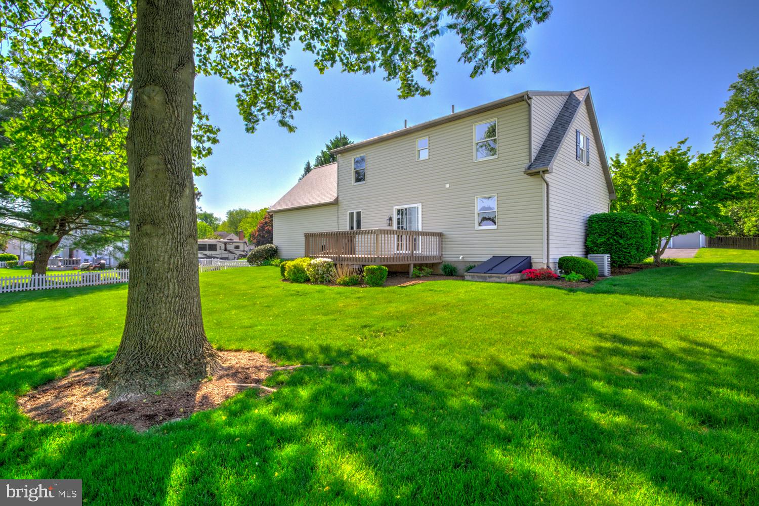 706 Rosemont Drive Lititz, PA 17543 - Photo 10 of 42 Sunny backyard oasis with lush greenery.